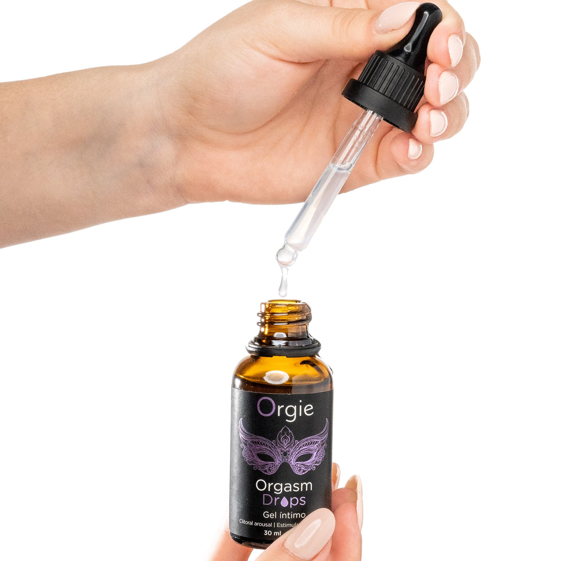 Hand holding a bottle of Orgie Orgasm Drops with a dropper.