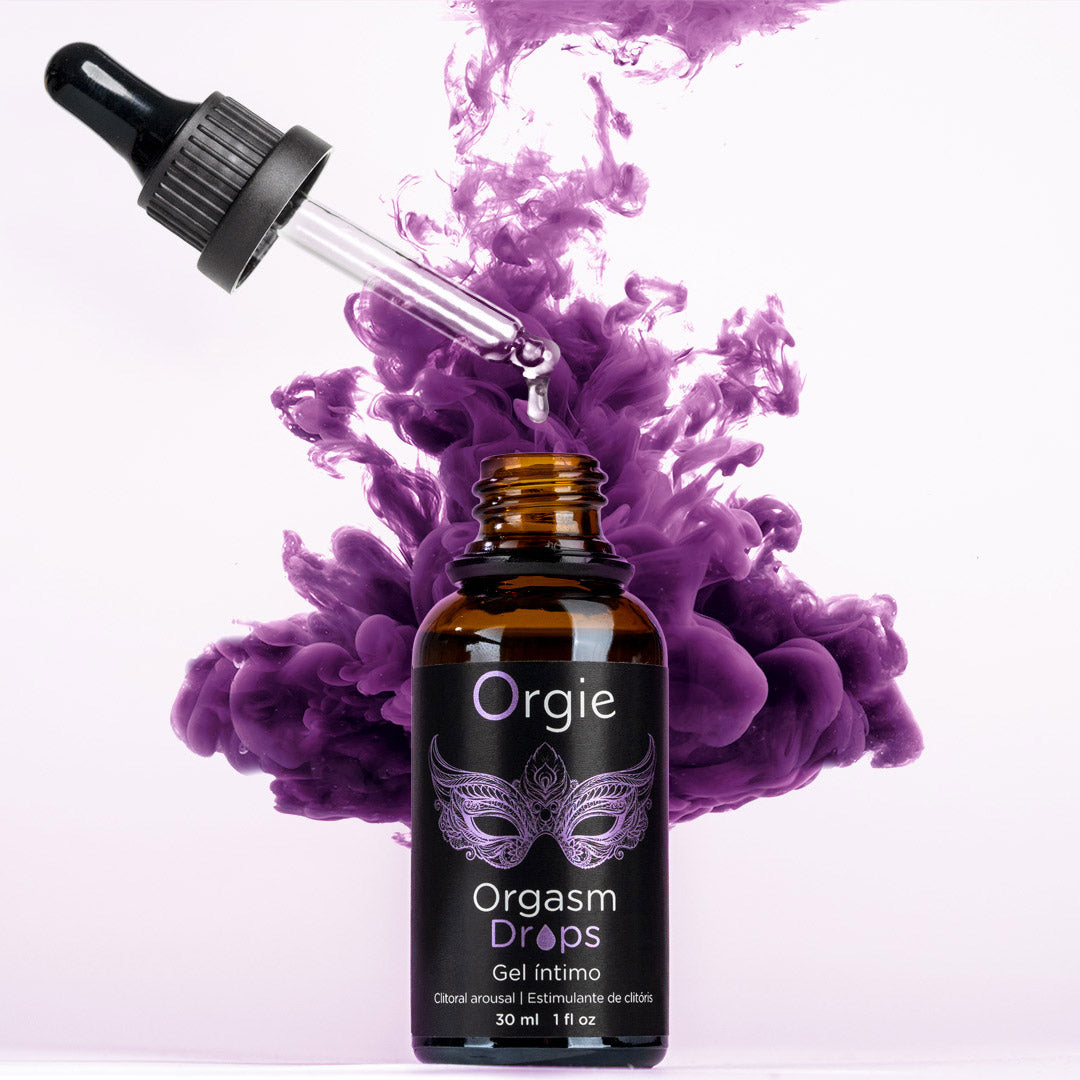 Bottle of Orgie Orgasm Drops with a dropper against a purple smoke background