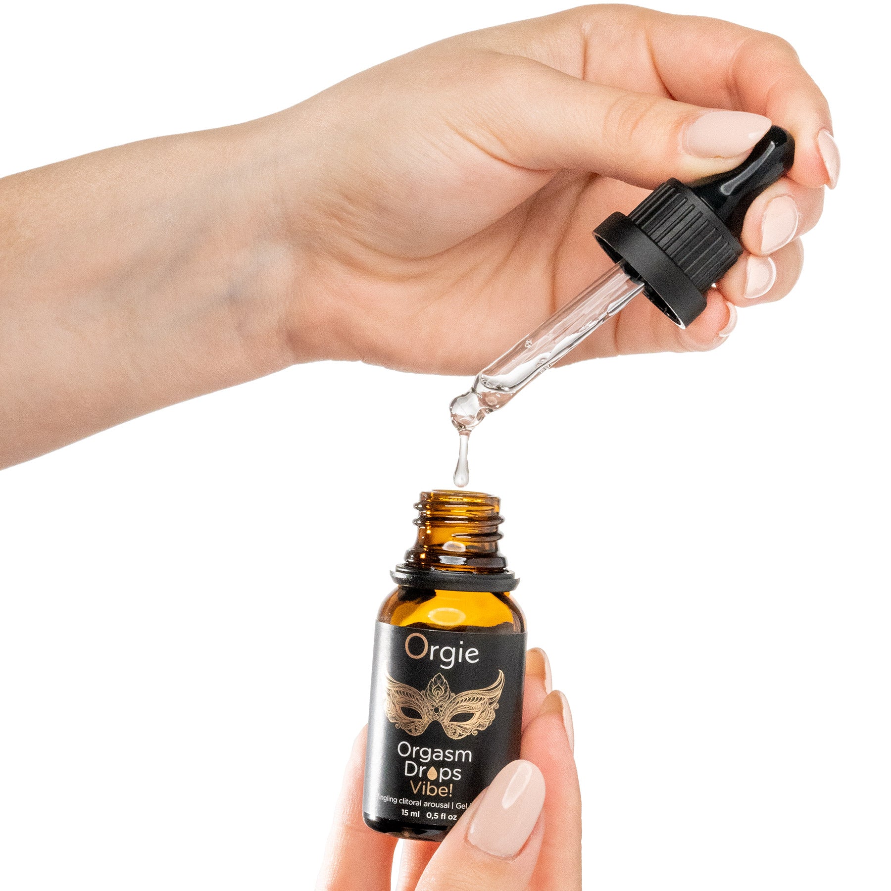 Hand holding a bottle of Orgie Orgasm Drops with a dropper.