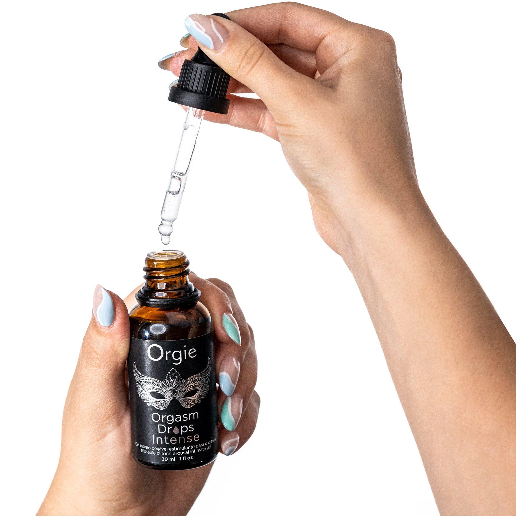 Hand holding a bottle of 'Orgie Orgasm Drops Intense' with a dropper against a white background