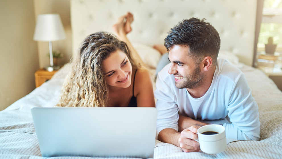 Couple discussing intimacy while using a laptop