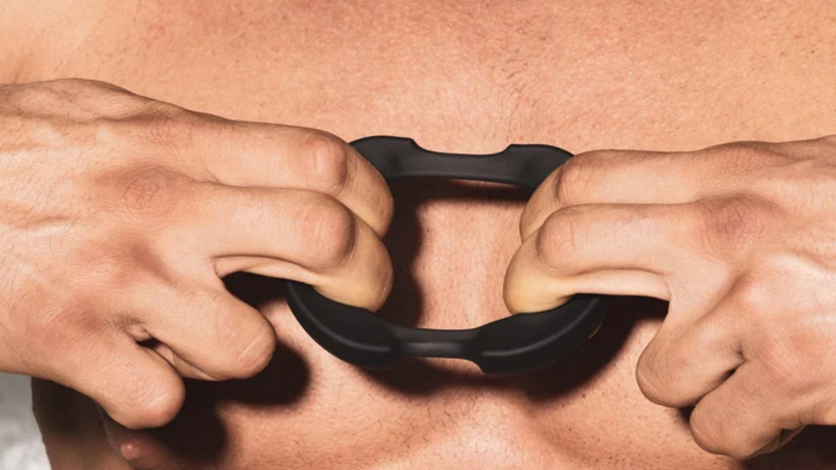 Person holding a flexible cock ring