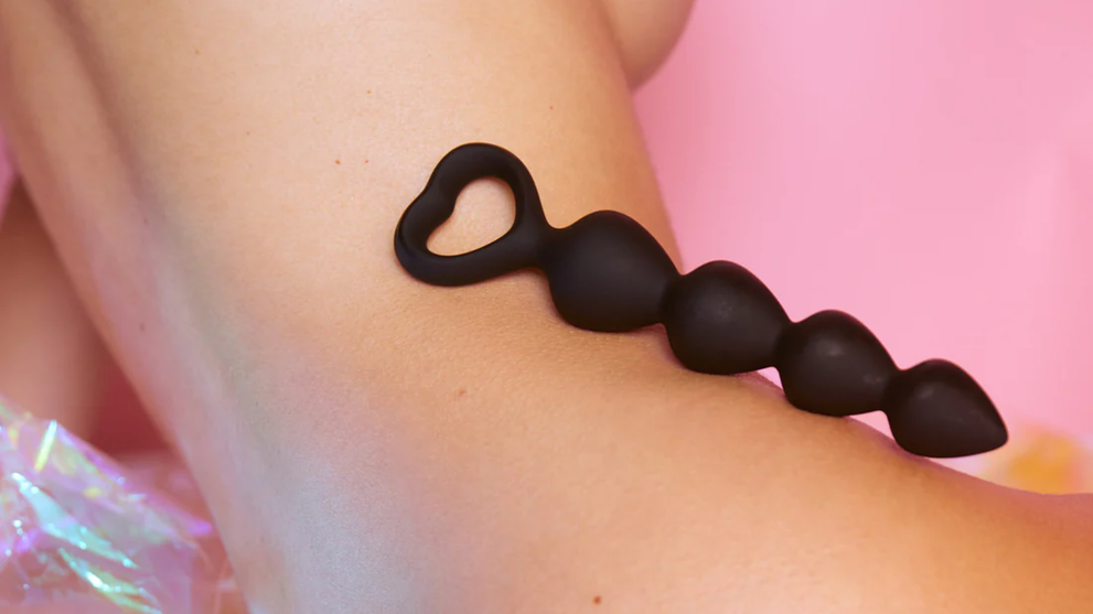 Silicone anal beads with flared base on leg