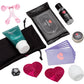 A wellness gift set arranged on a white background, including a pink silicone baby teether, a black pouch of Lovehoney wipes, a teal tube of Water-Based Lubricant, a small black bottle of Vanilla Massage Oil, a round tin of Menthol Pleasure Balm, lavender cards, two pink sequined heart pasties, a black toy bag, and a white stroker.
