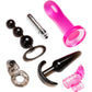 Six adult novelty accessories arranged on a plain white background: a translucent bright pink plug, a black beaded anal plug with ring, a silver cylindrical piece, a black curved plug, a clear ring, and a translucent pink double-piece piece.