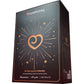 A tall rectangular product box for a 24 Day Luxury Calendar by Lovehoney, shown at a three-quarter angle on a plain white background. The box is black with metallic rose gold accents, including a large heart-shaped cutout in the center, radiating lines, stars, and small heart motifs.