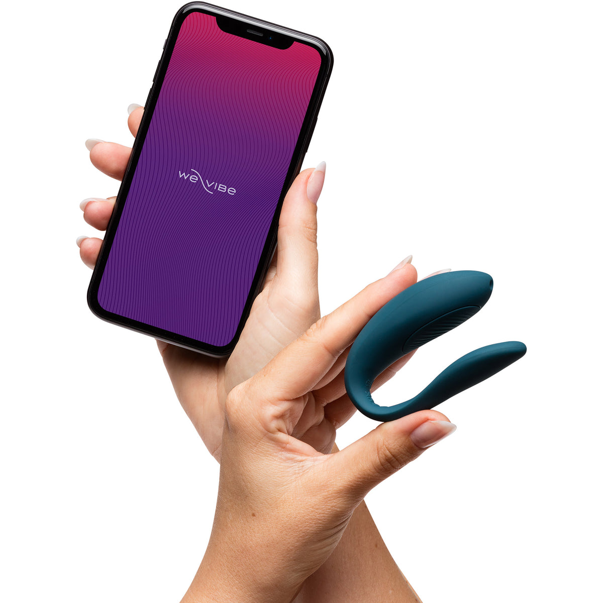 A hand holding a smartphone with the We-Vibe logo on the screen, while the other hand holds a teal U-shaped personal massager against a solid white background.