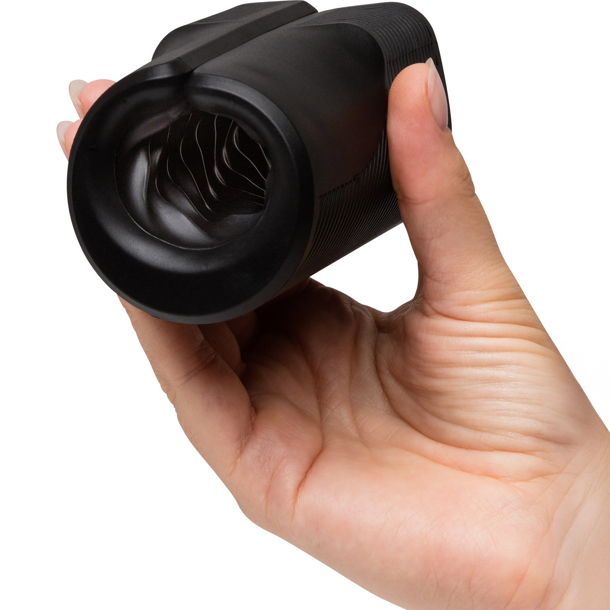A hand holding a black textured cylindrical personal massager with a flared opening, shown against a plain white background.