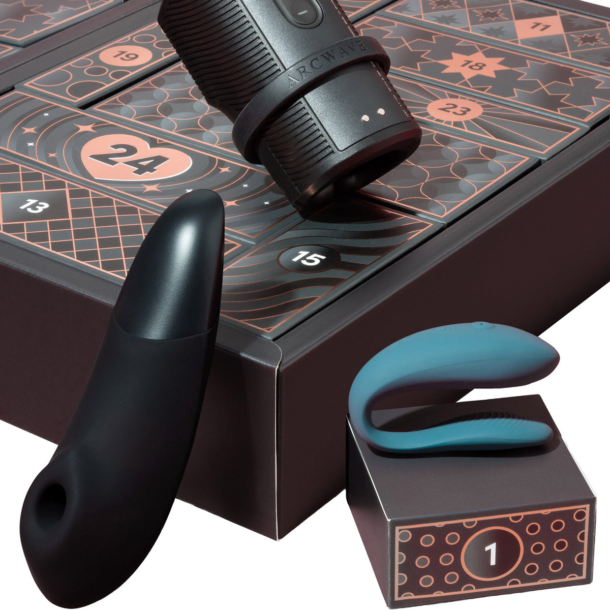 Sex toy set with a matte black curved vibrator, a black cylindrical wand-style piece, and a teal curved insert, arranged with a dark patterned box featuring numbered compartments.