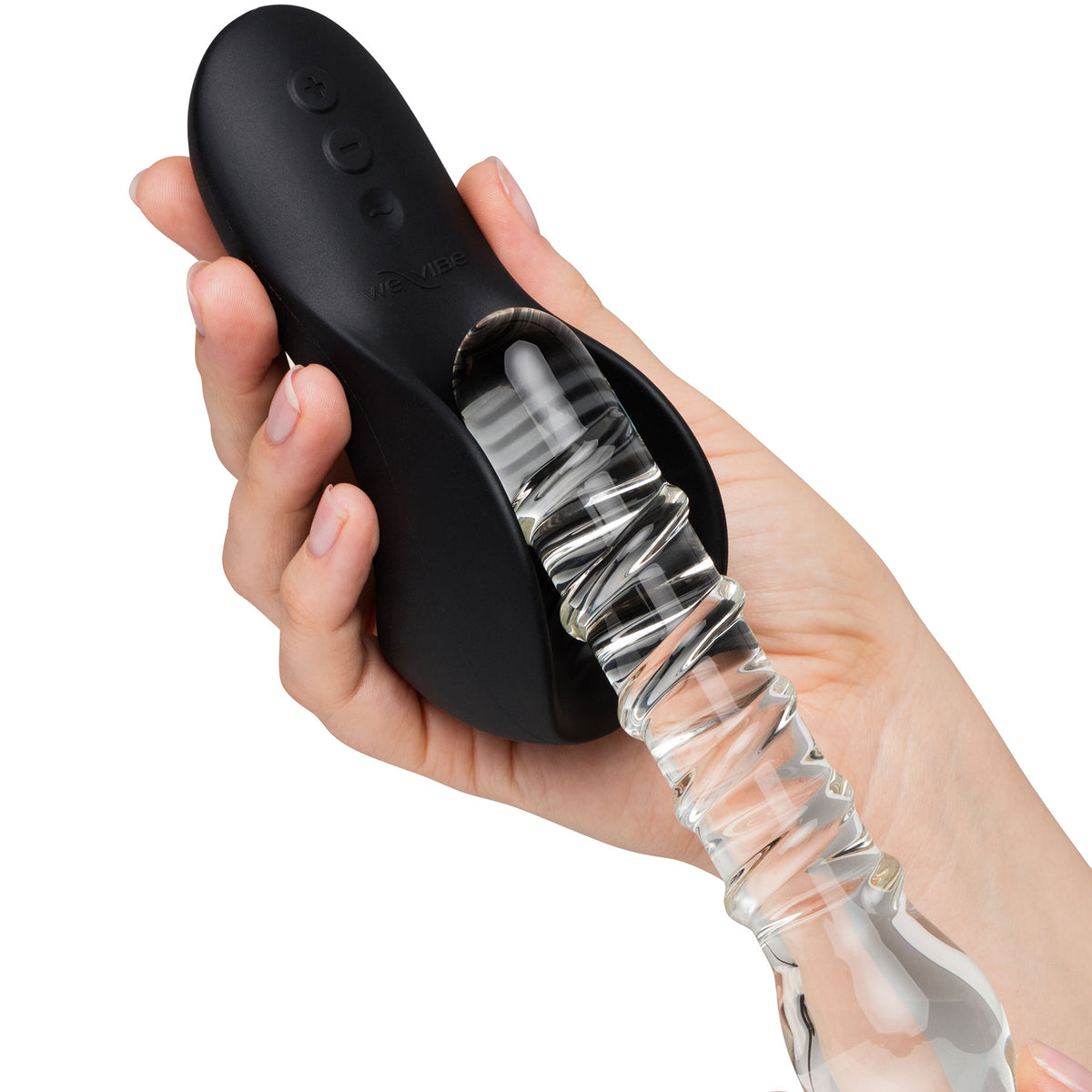A hand holding a black personal massager with a clear, flexible, ribbed glass dildo enveloped, shown against a plain white background.