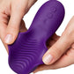 A close-up of a purple personal massager being held between two hands, showing the textured body and control buttons on the top, with the brand name 'We-Vibe' visible.