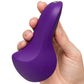 A hand holding a purple, curved personal massager against a plain white background.