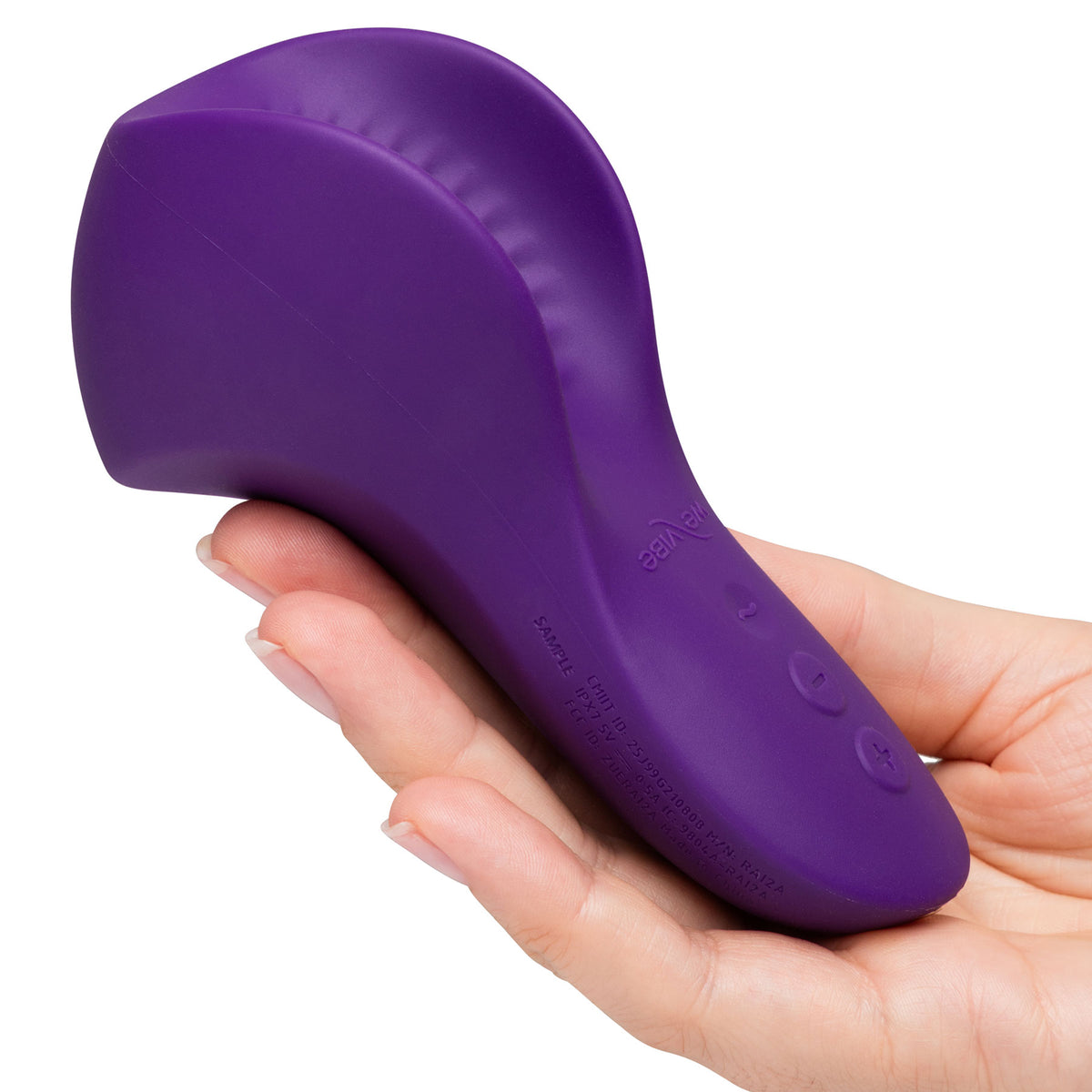 A purple personal massager held in a person's hand against a plain white background.